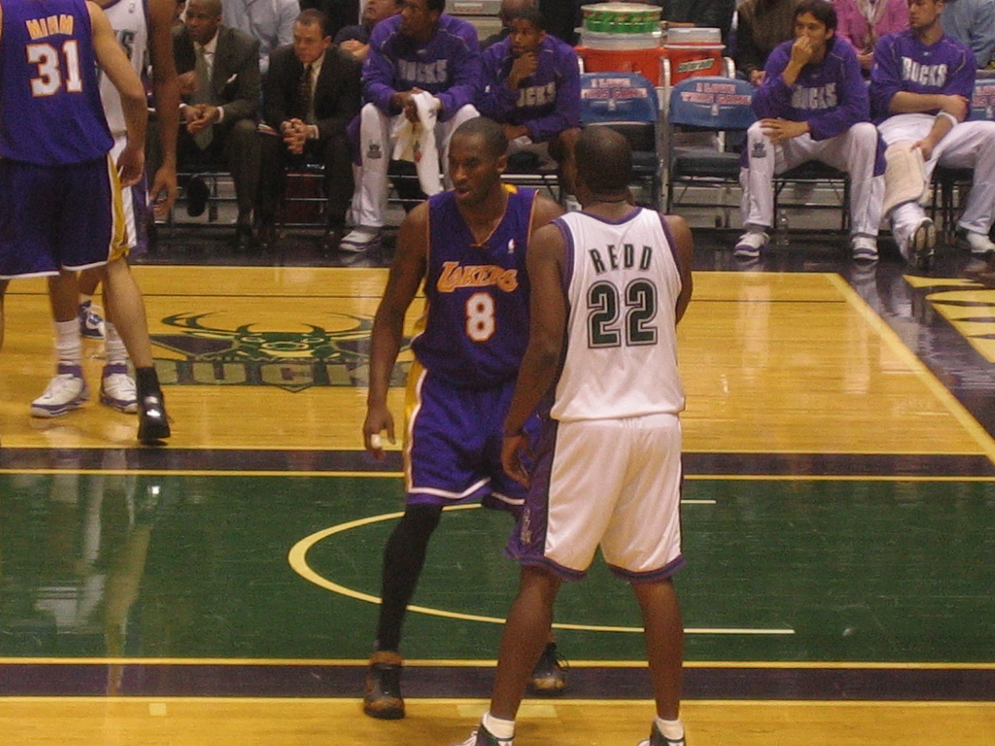 Download Kobe Bryant, the sports legend, smiling beside his