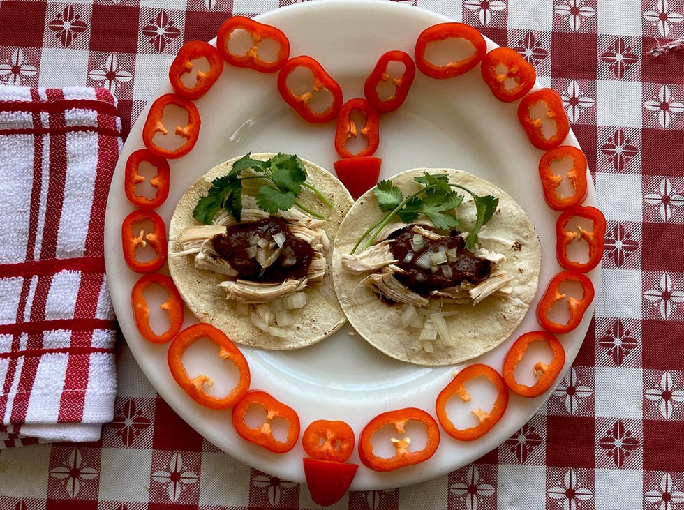 Mole chicken tacos on plate with pepper slices heart shape