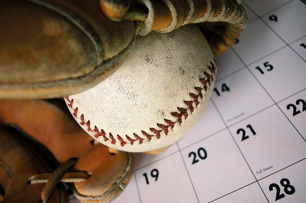 Baseball in glove on calendar