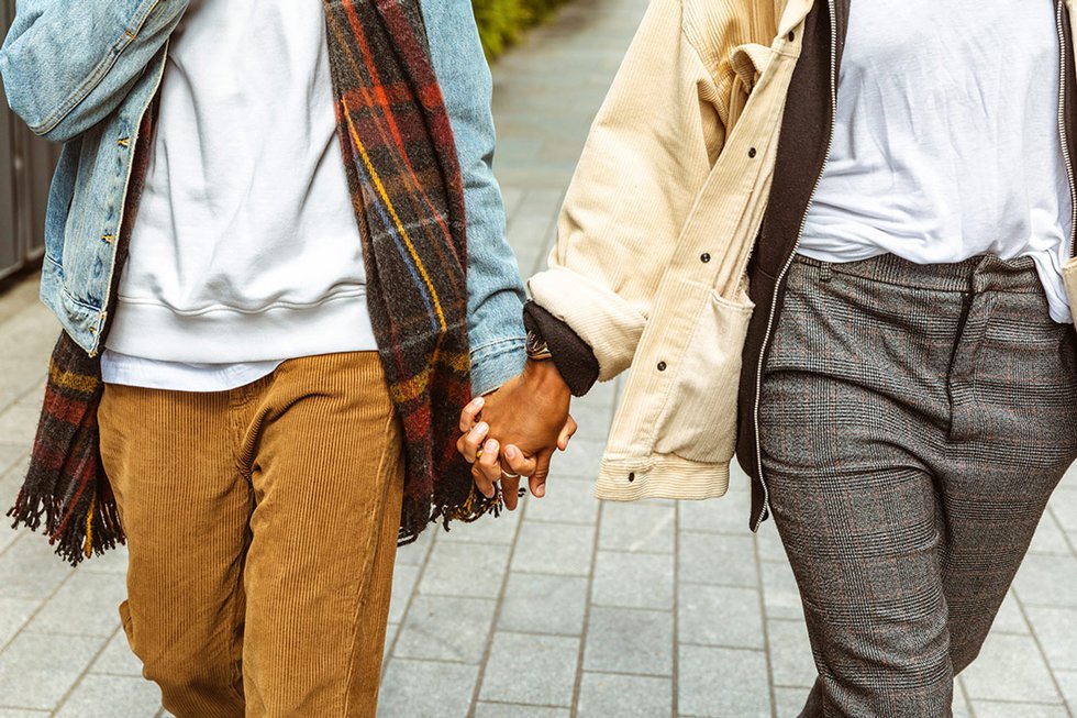 Multiracial LGBTQ couple holding hands
