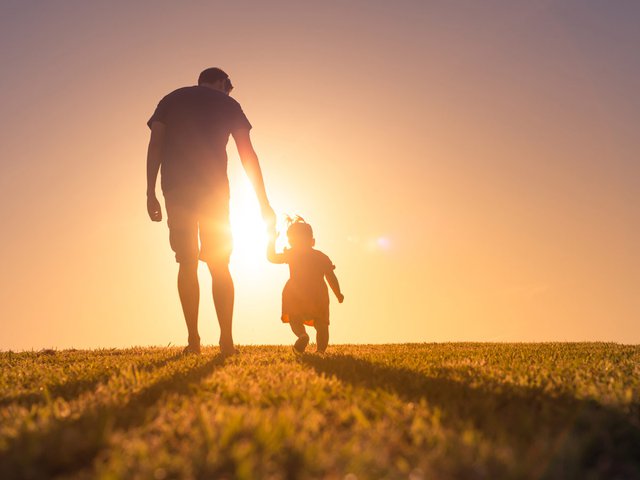 father-and-toddler-walking-up-hill