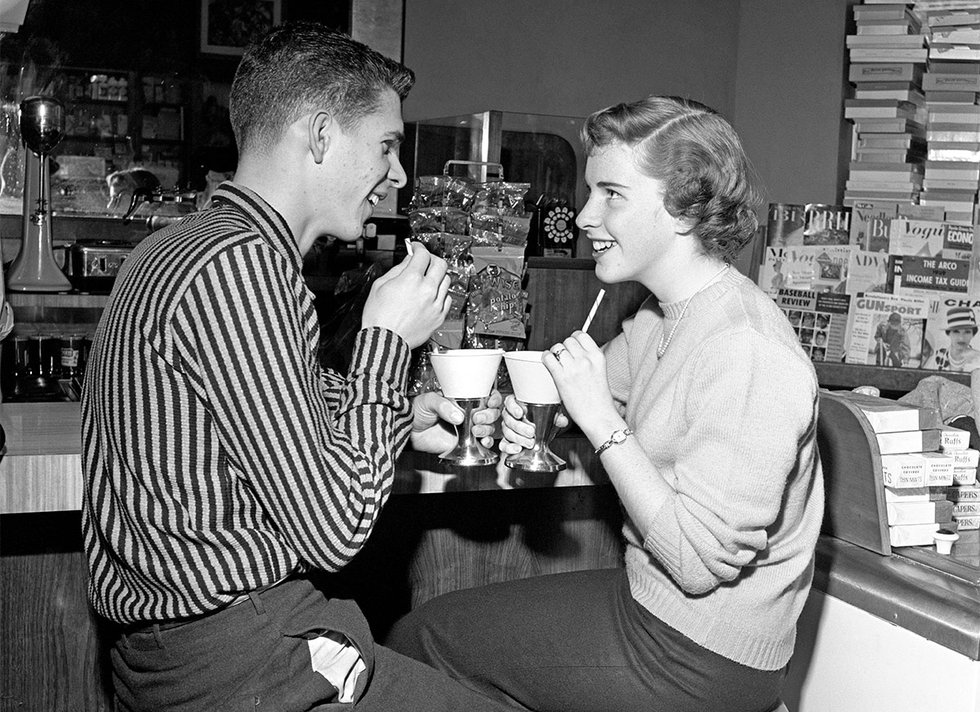 1950s teenage couple at soda fountain