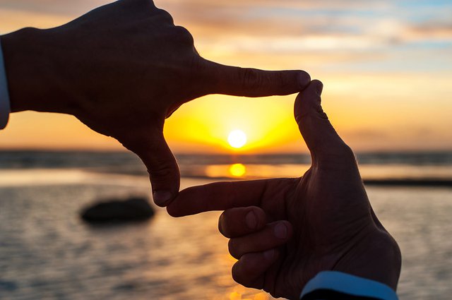 Framing sunset with hands