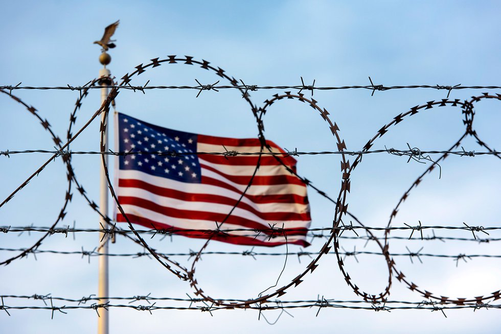 US Flag behind barbed wire